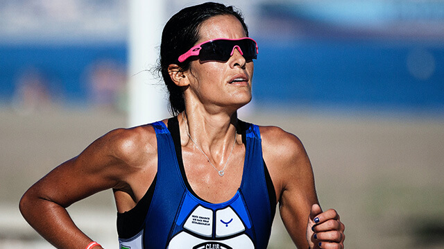 An athlete running in an event, wearing sport sunglasses