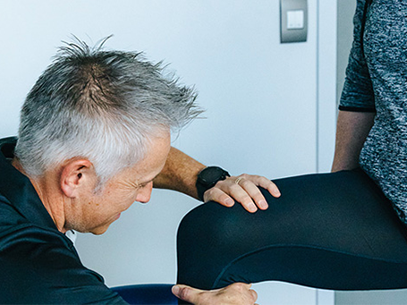 A physiotherapist works on a patients knee